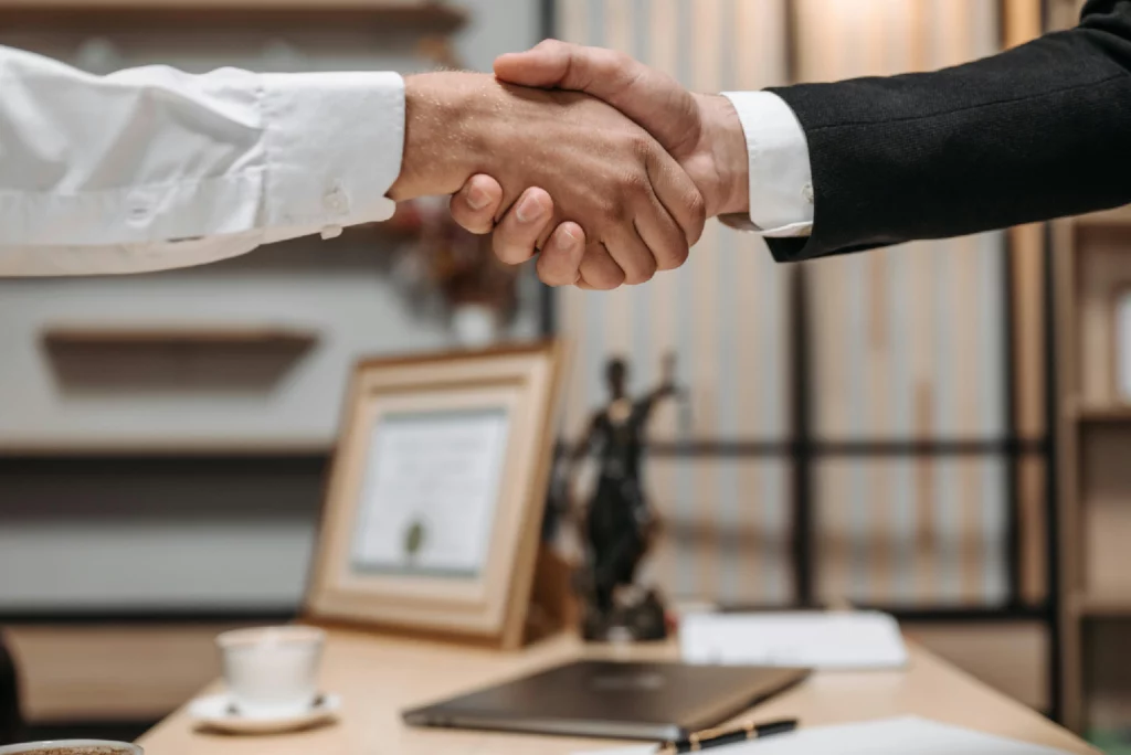 Attorney and client shaking hands